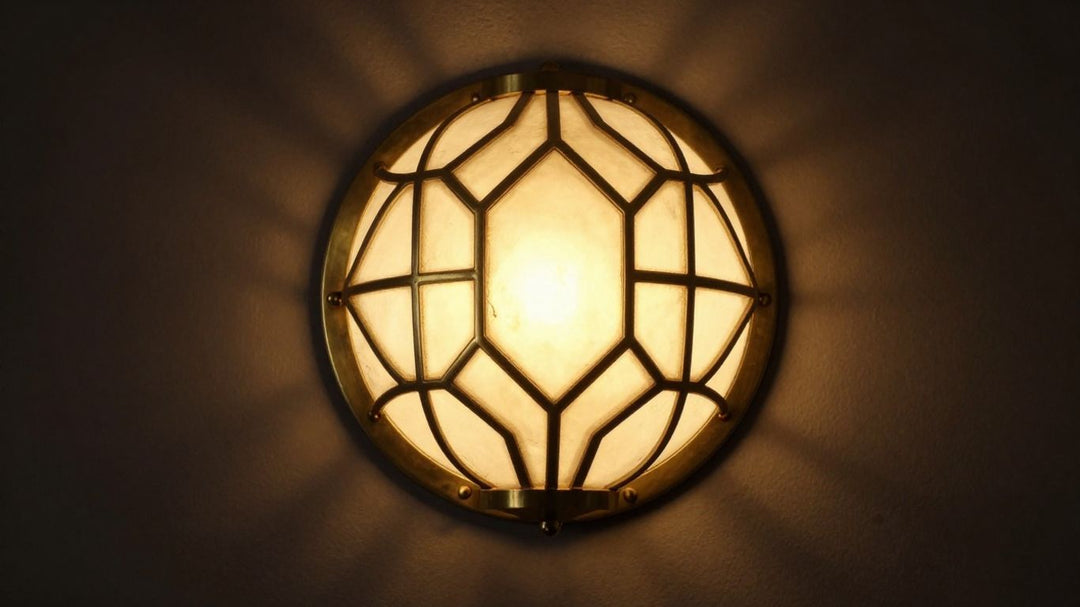 Art Deco wall light fixture with brass and glass details.