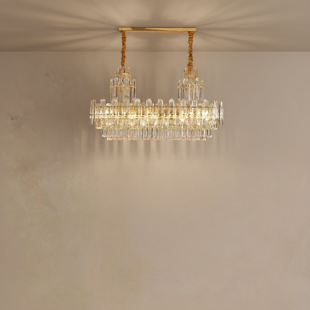 Gold chandelier with crystal accents on a beige wall