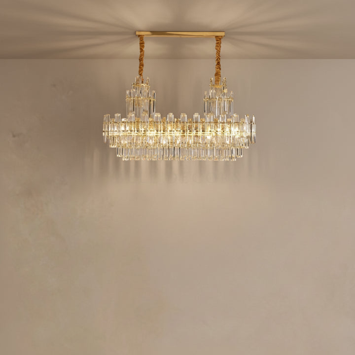 Gold chandelier with crystal accents on a beige wall