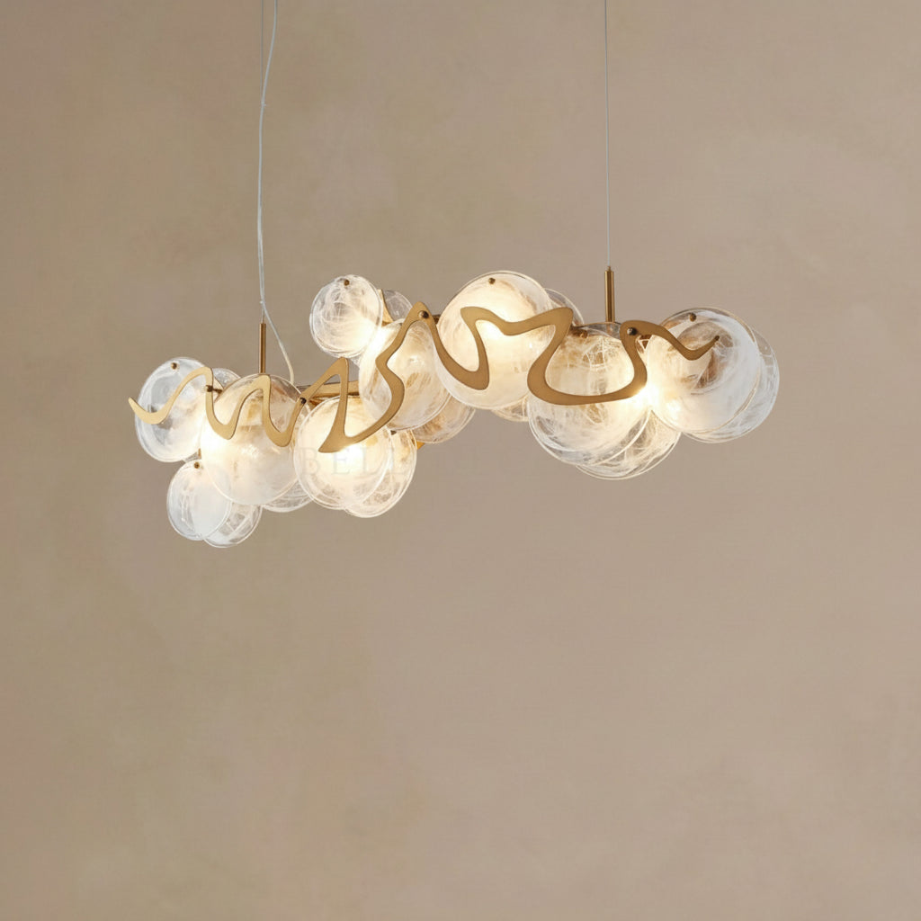 Modern chandelier with glass bubbles and gold accents on a beige background