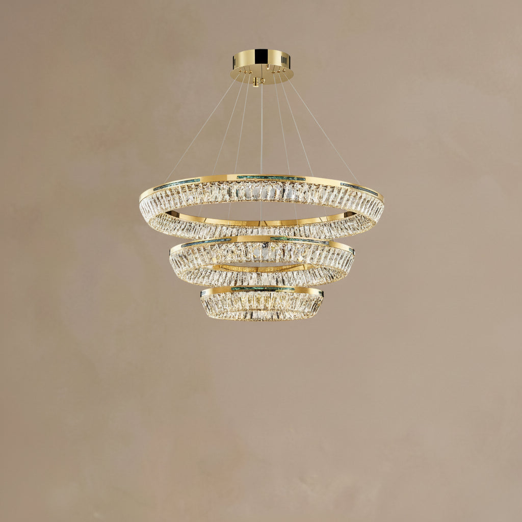 Gold chandelier with crystal accents on a beige background