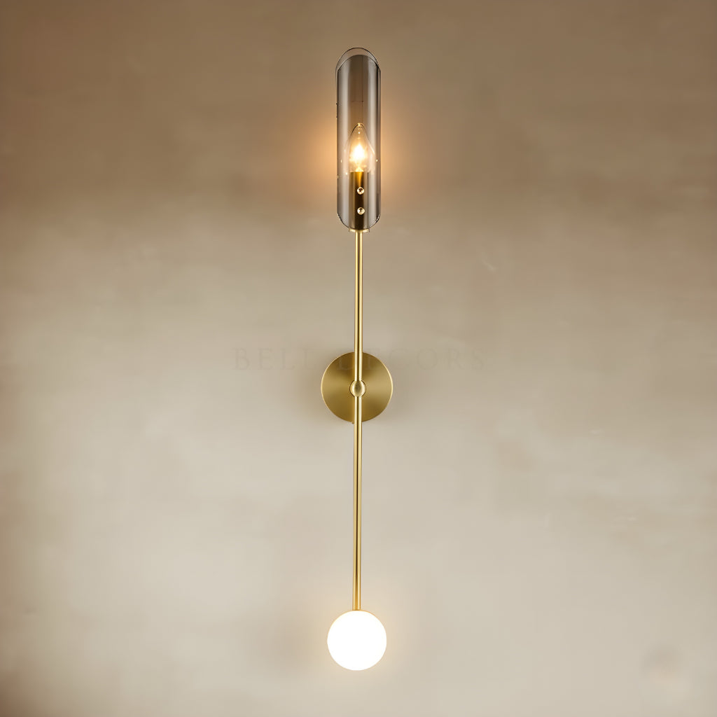 Modern wall light fixture with gold accents on a beige wall