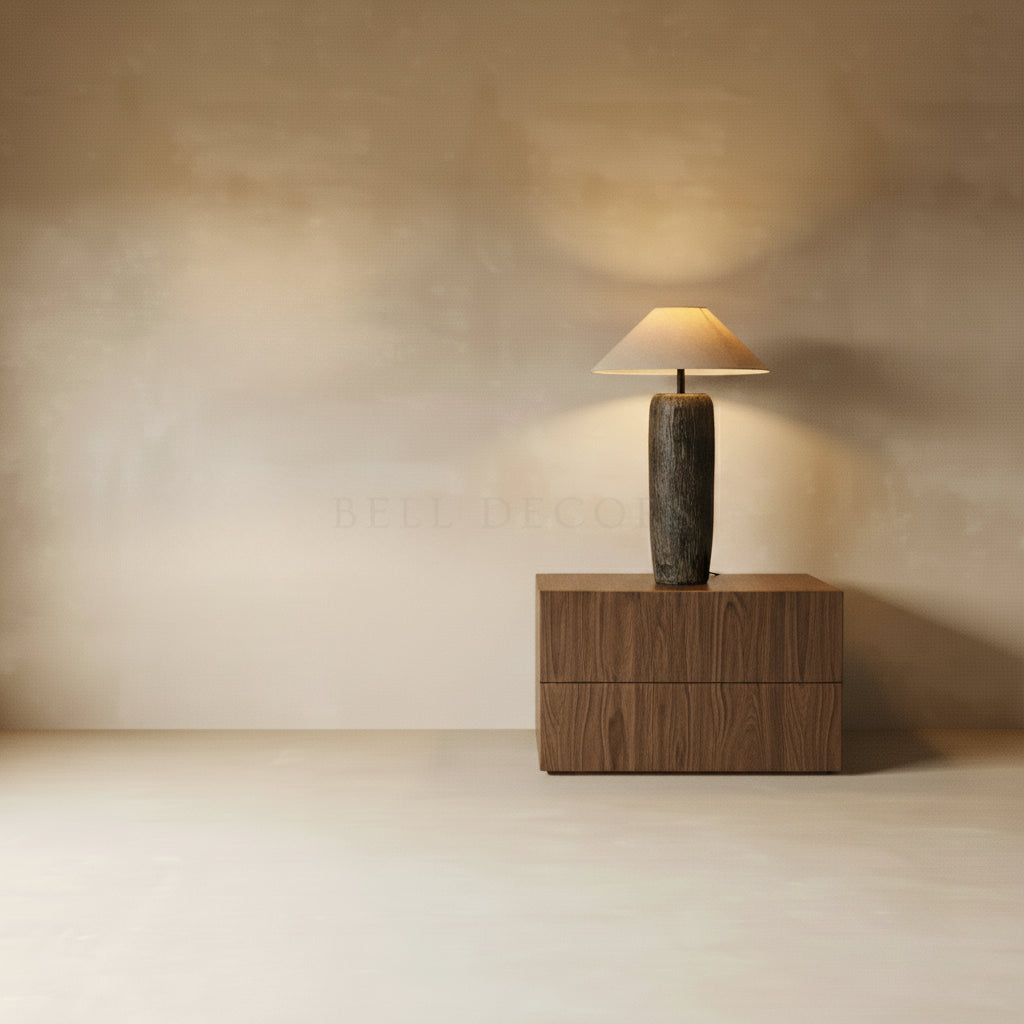 Modern table lamp on a wooden side table against a beige wall.
