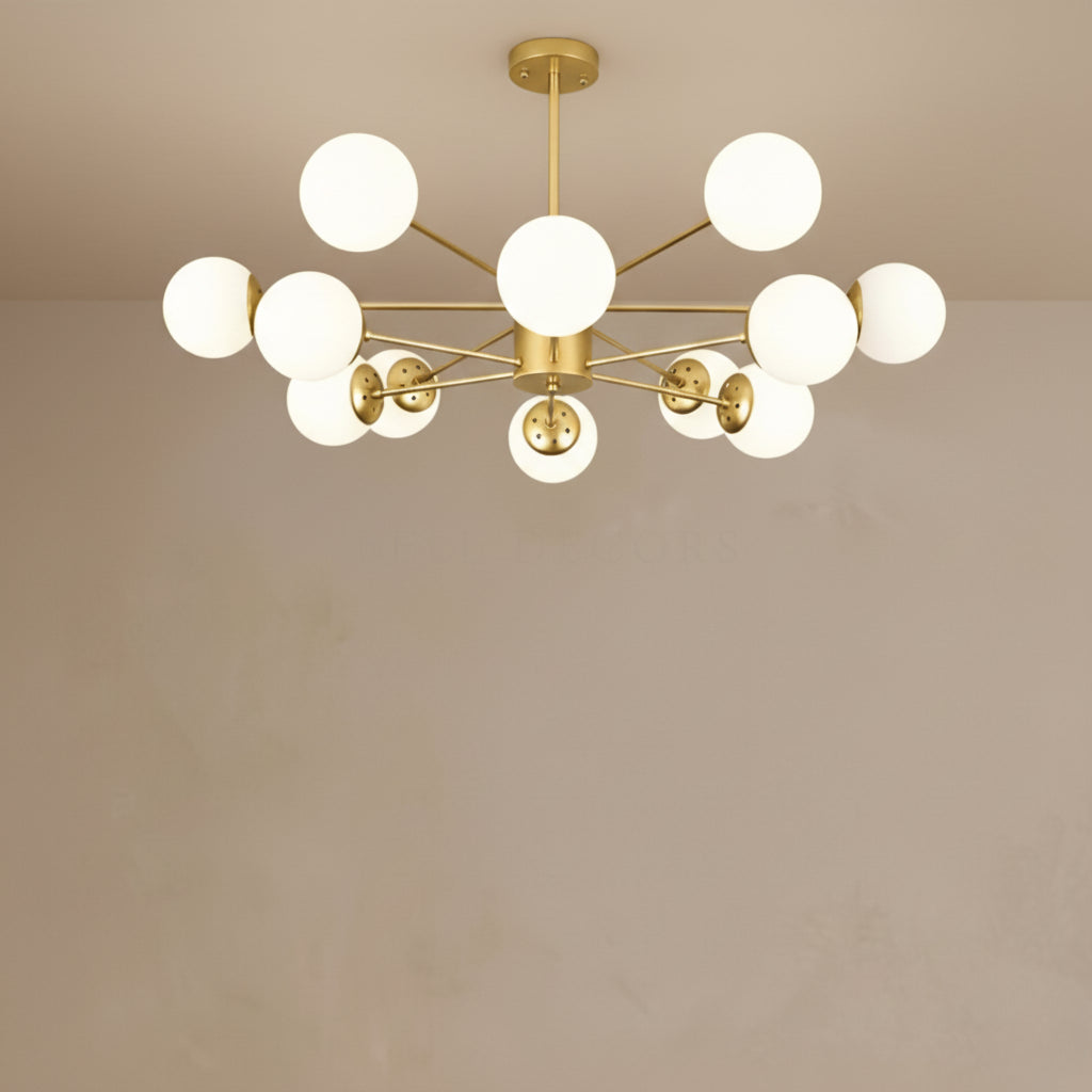 Modern chandelier with gold fixture and white glass bulbs on a beige background