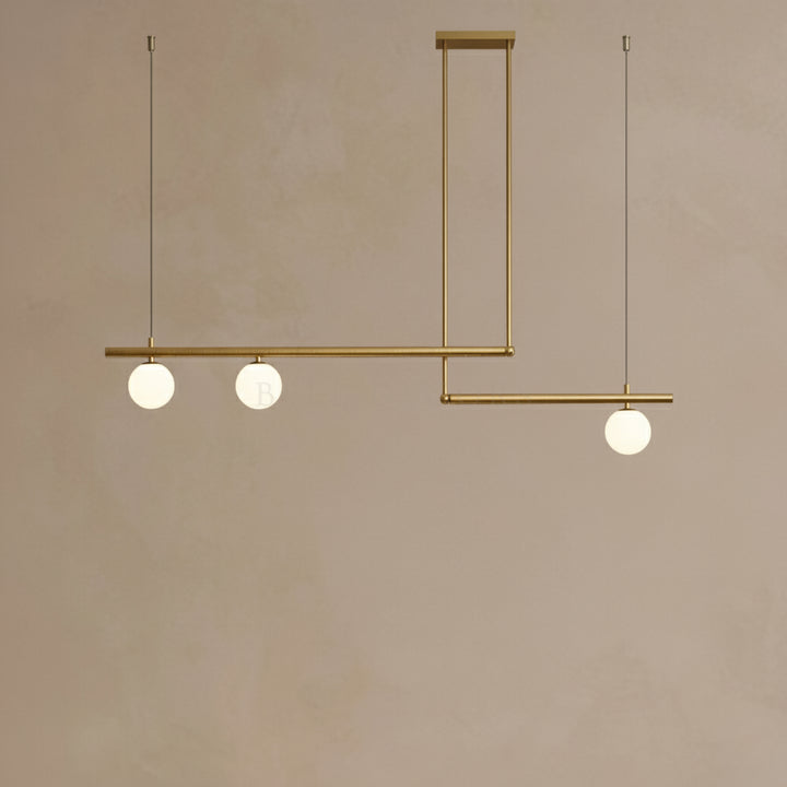 Modern pendant light with three spherical bulbs on a beige background