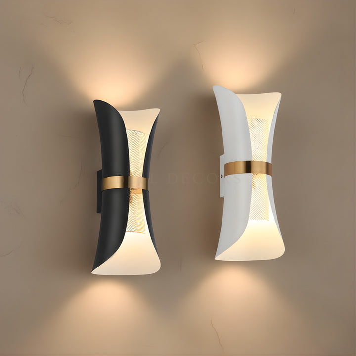 Two modern wall lights with black, white, and gold design on a beige wall.