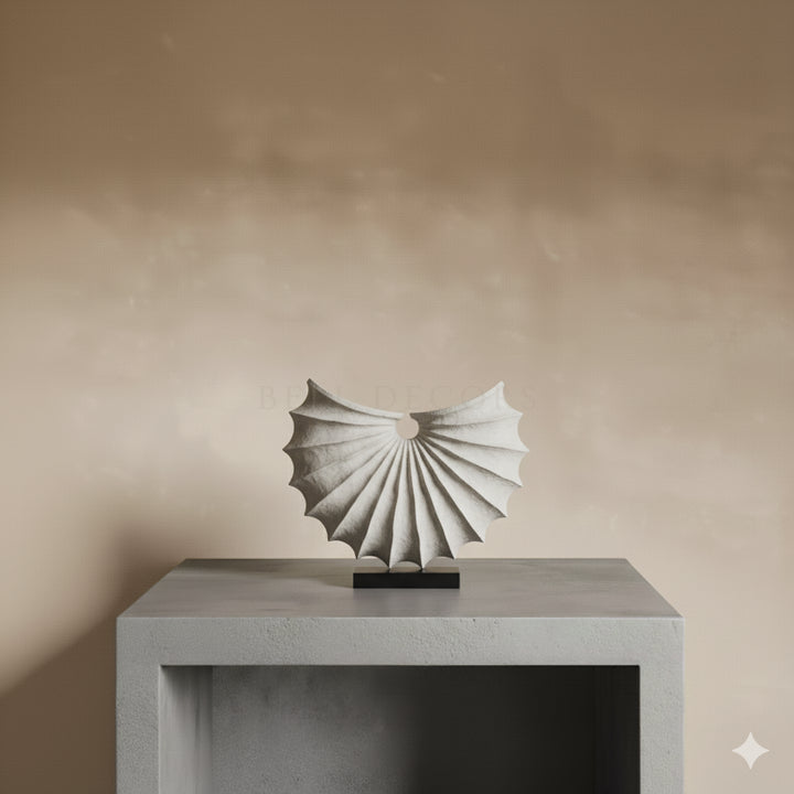 Abstract sculpture on a pedestal against a beige wall