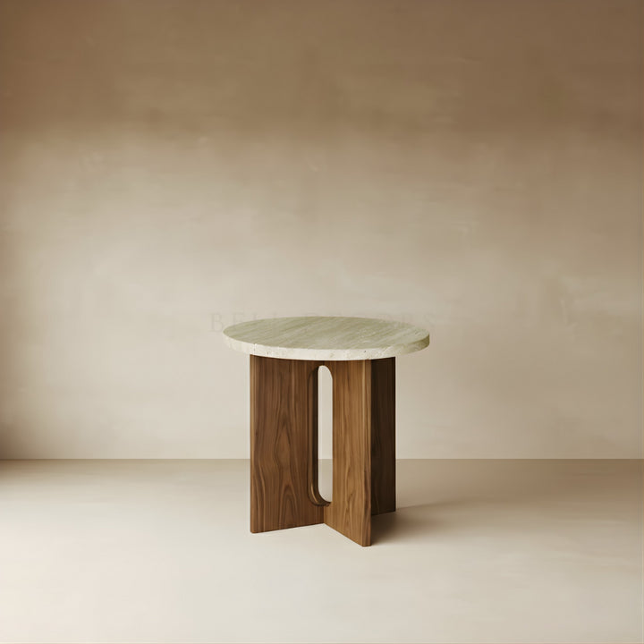 Small round table with marble top and wooden base against a beige wall.