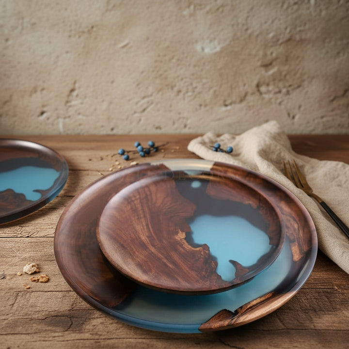 Wooden plates with blue resin inlay on a wooden surface