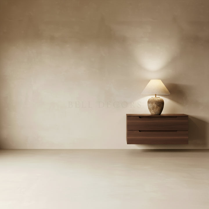 Wooden wall-mounted shelf with a lamp against a plain wall