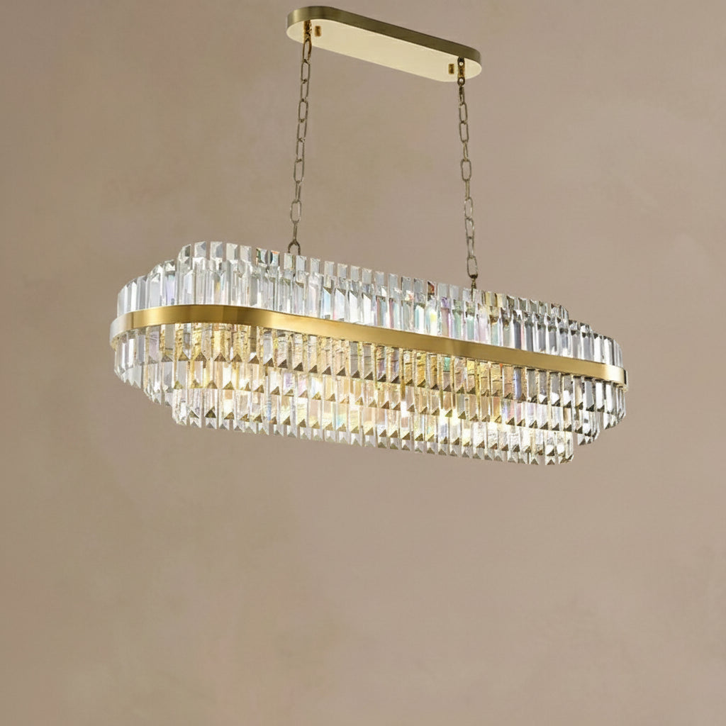 Gold and crystal chandelier against a beige wall
