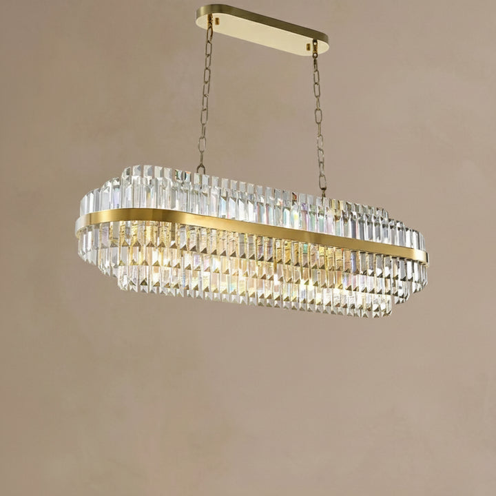 Gold and crystal chandelier against a beige wall