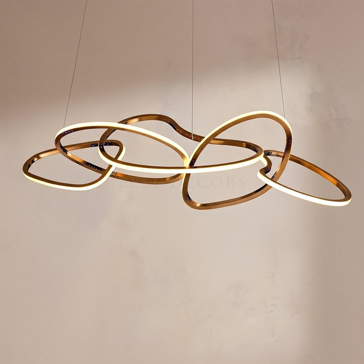 Modern chandelier with interlocking rings on a plain background