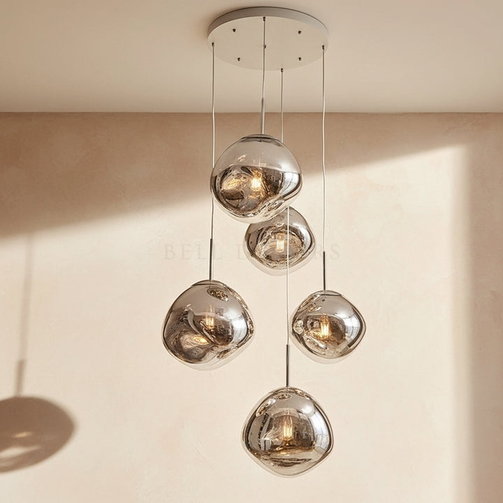Modern pendant light with glass shades on a neutral background