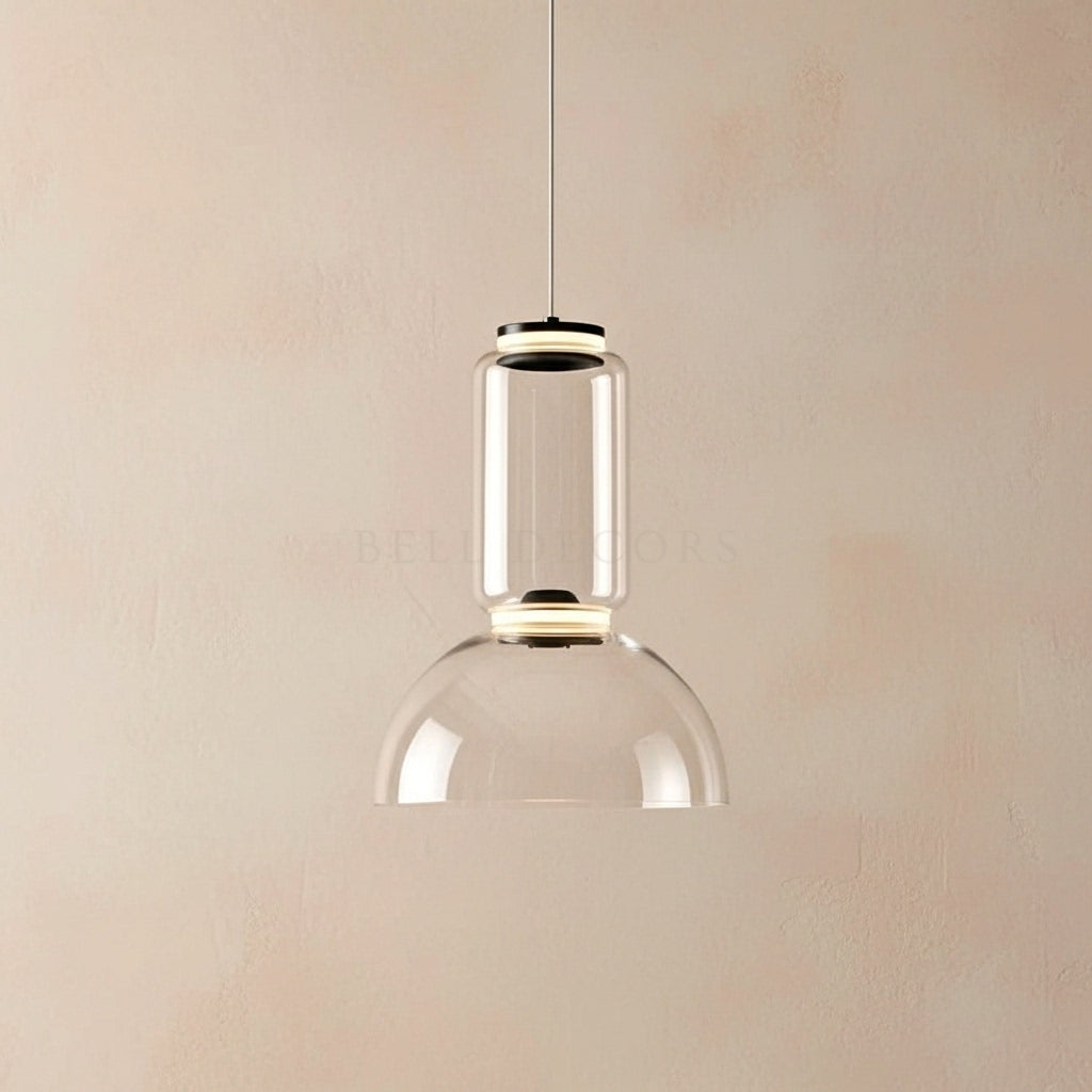 Clear glass pendant light against a beige wall
