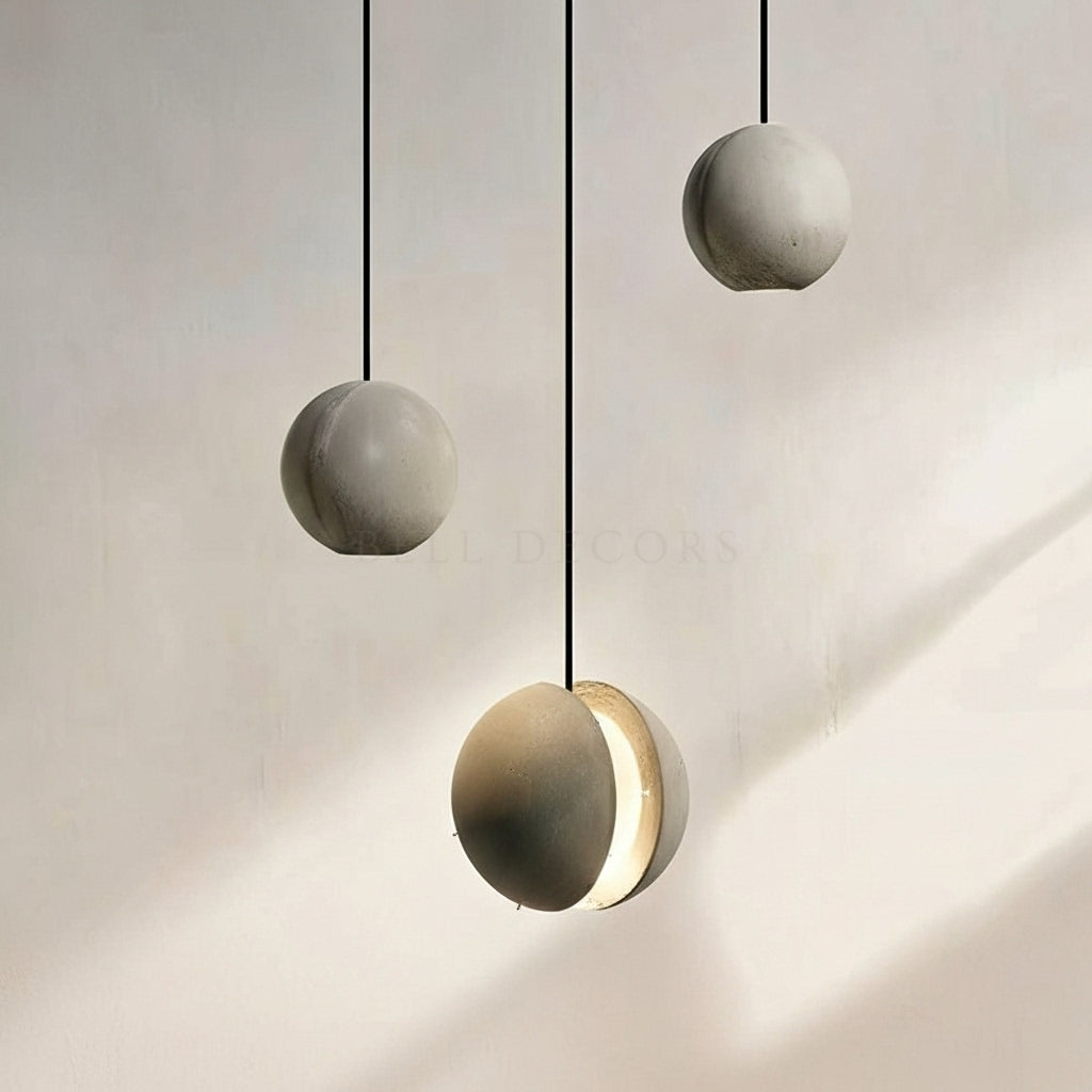 Modern pendant lights with concrete-like finish on a neutral background