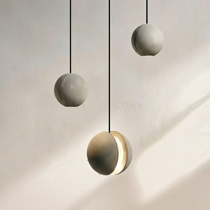 Modern pendant lights with concrete-like finish on a neutral background