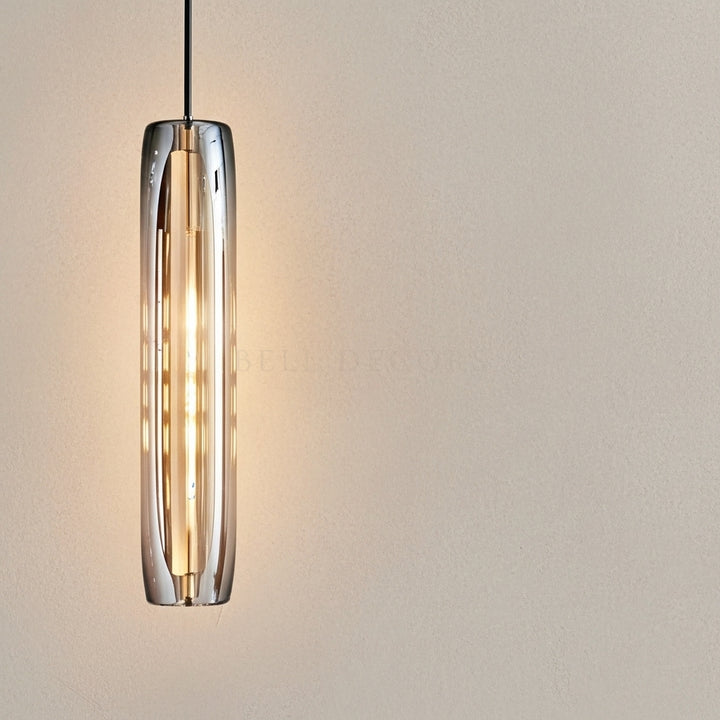 Modern pendant light with cylindrical glass shade on a neutral background