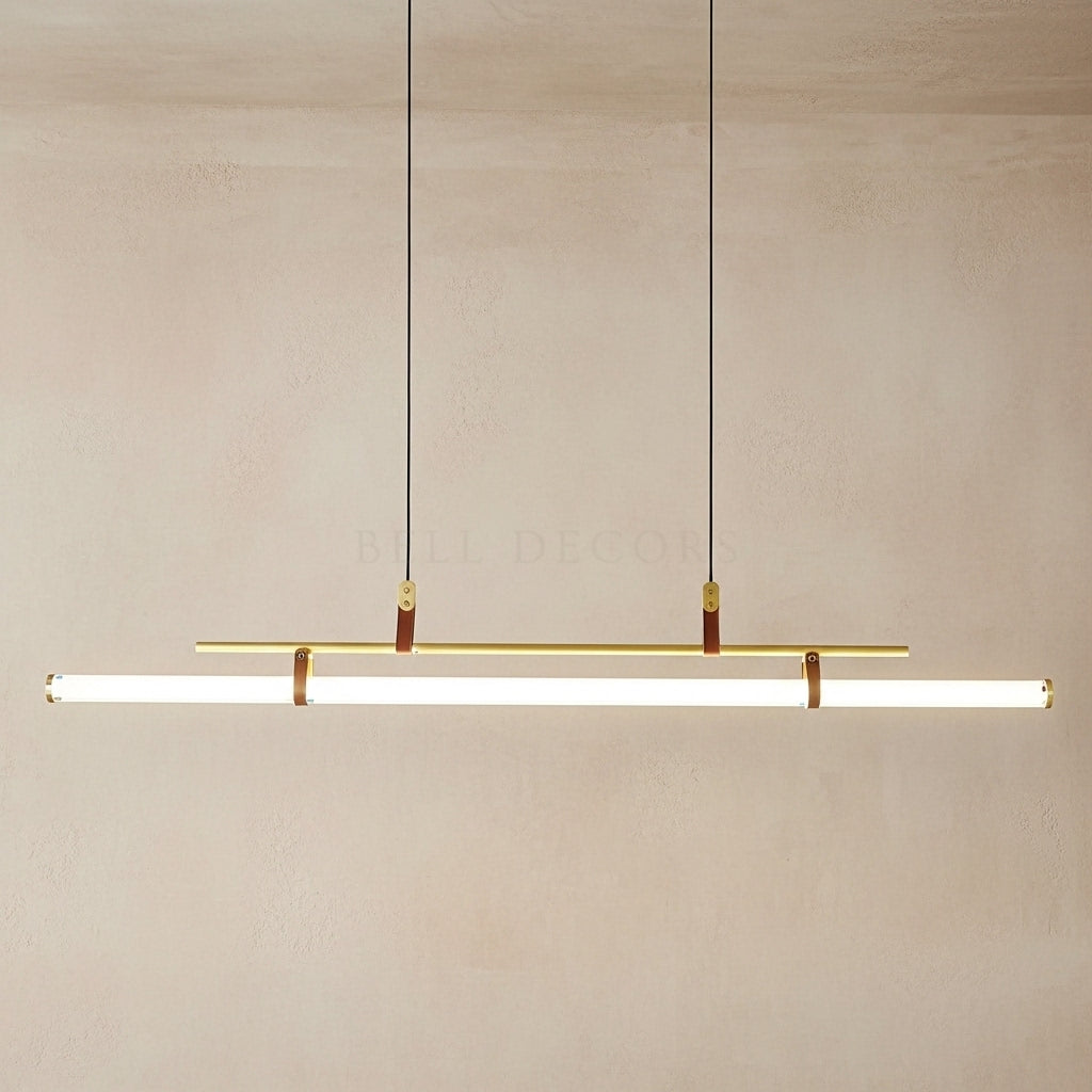 Modern pendant light fixture with gold accents on a neutral background