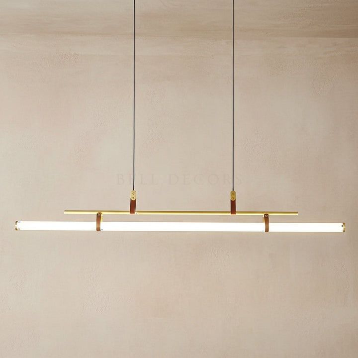 Modern pendant light fixture with gold accents on a neutral background