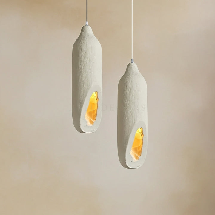 Two modern pendant lights with a textured design on a beige background