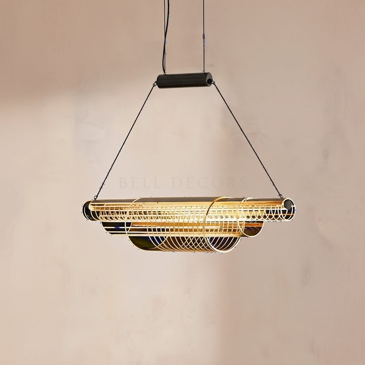 Modern pendant light with gold finish on a beige background