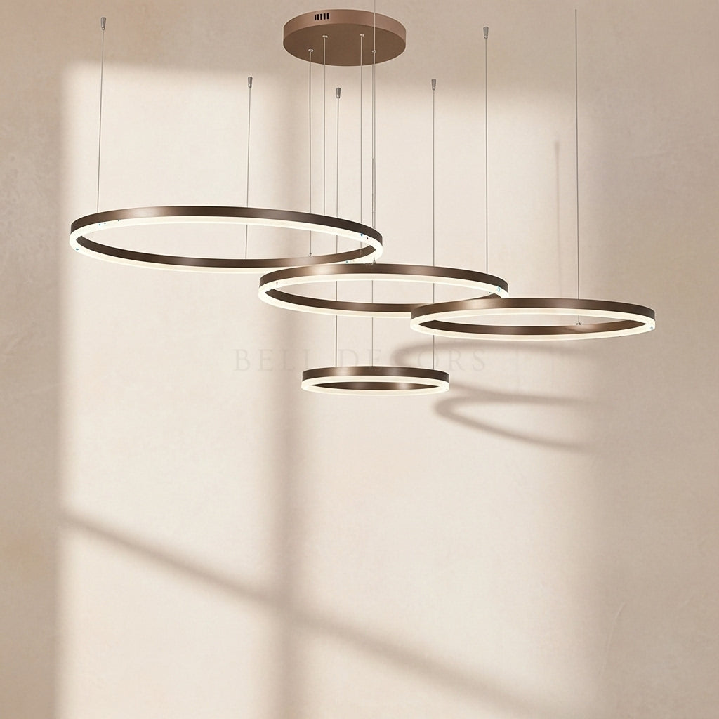 Set of four circular pendant lights on a neutral background