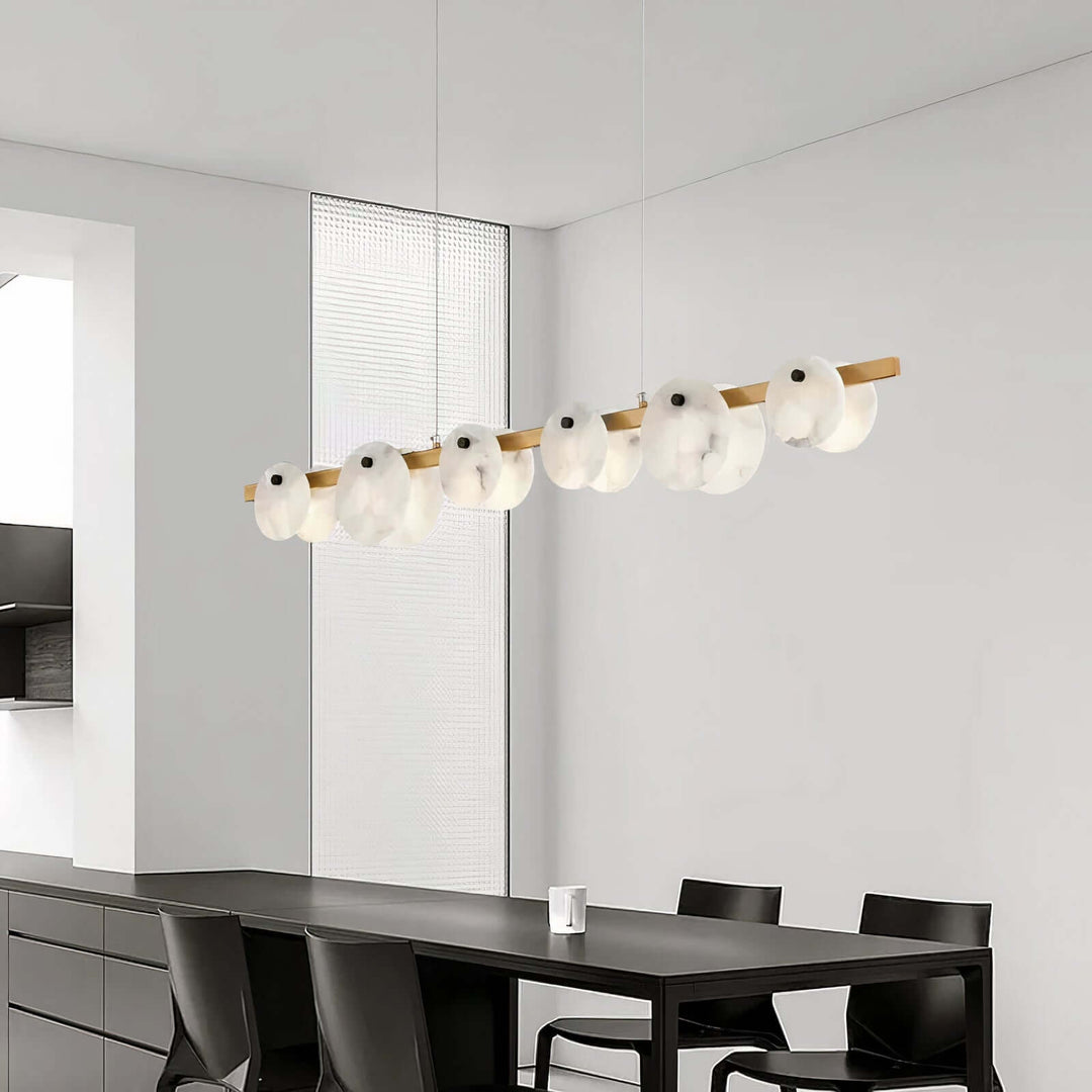 Foyer Chandelier - Linear Chandelier Dining Room illuminated above a modern dining table, showcasing elegant alabaster design.