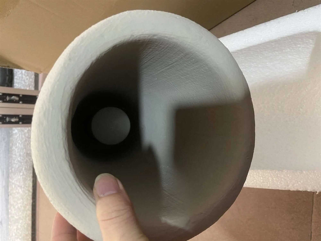 Inside view of a minimalist ceramic light fixture, showcasing smooth textures and interior design elements.