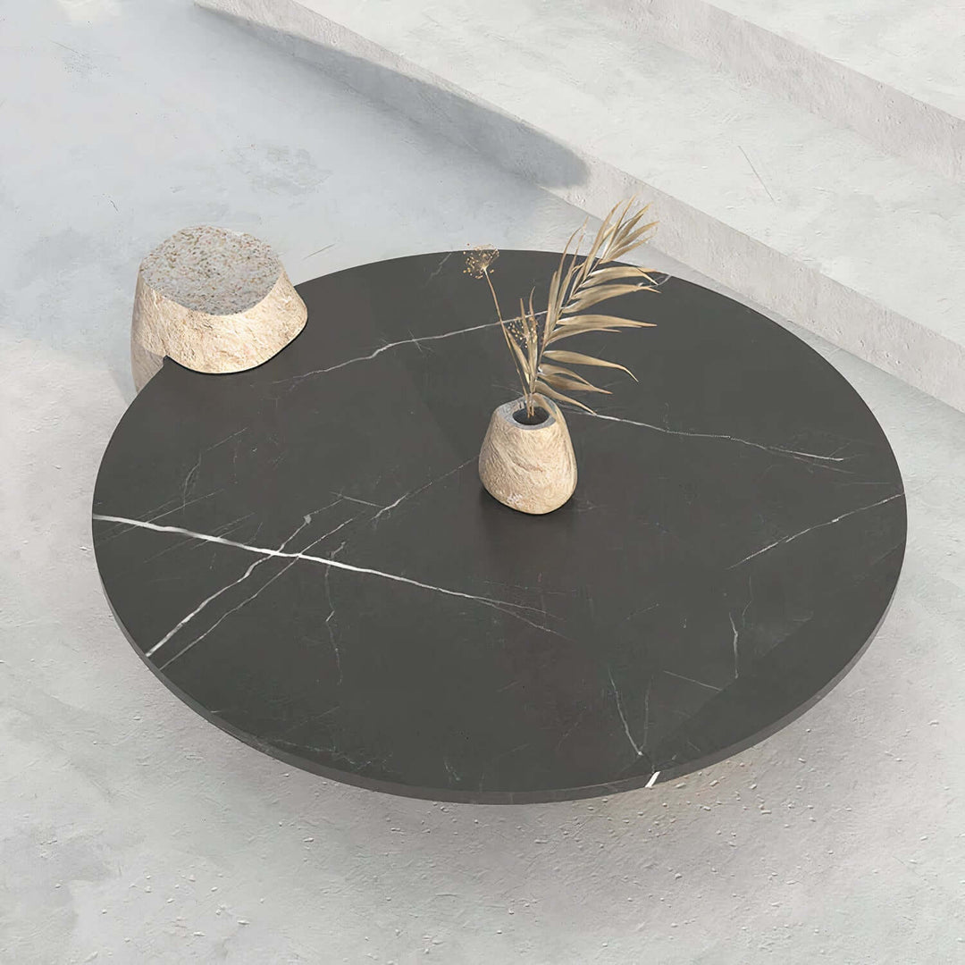 Black Coffee Table - Marble Coffee Table featuring a round black marble top with unique stone legs and decorative elements.