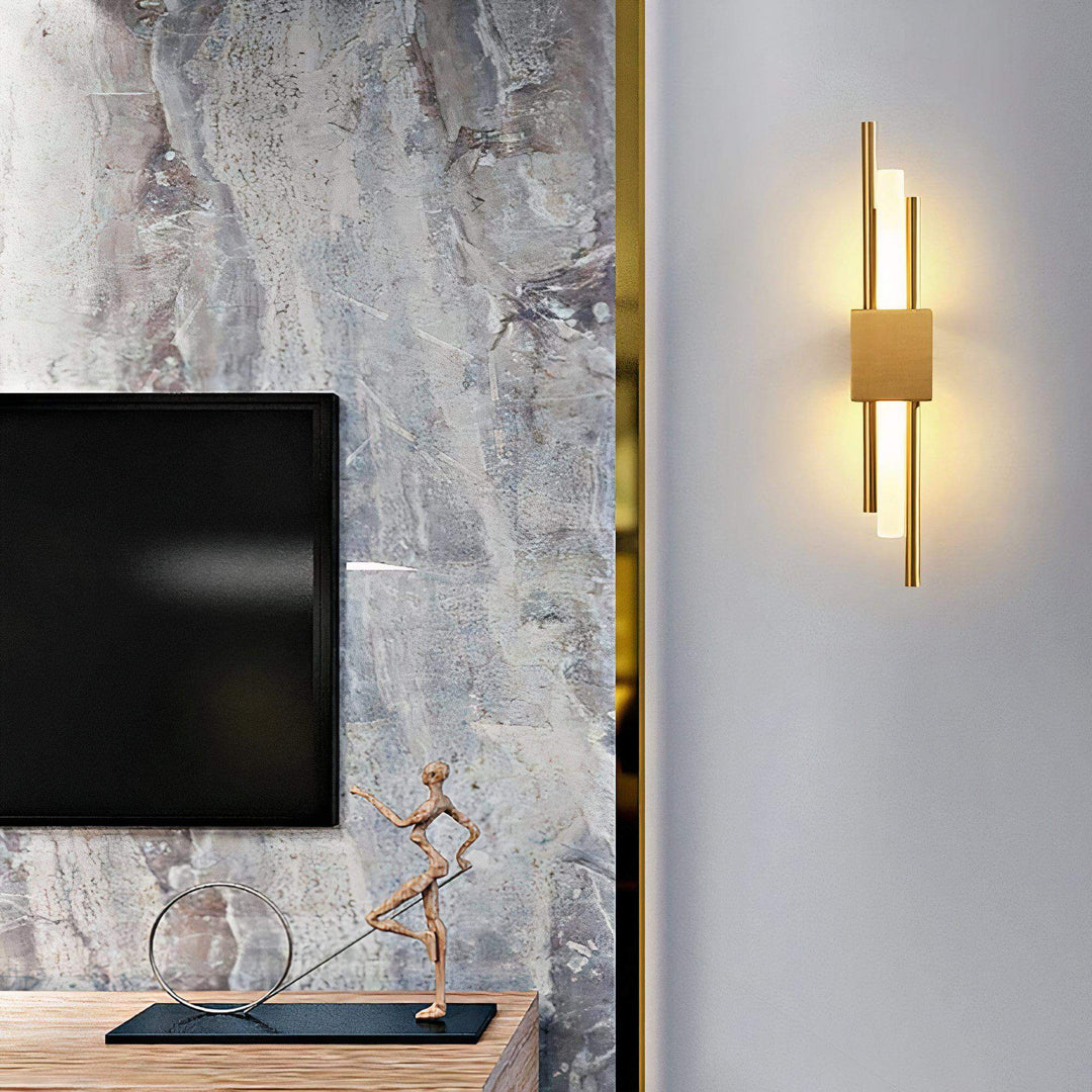 Gold Wall Light - Sleek Yet Contemporary illuminating a stylish interior with art and a television.