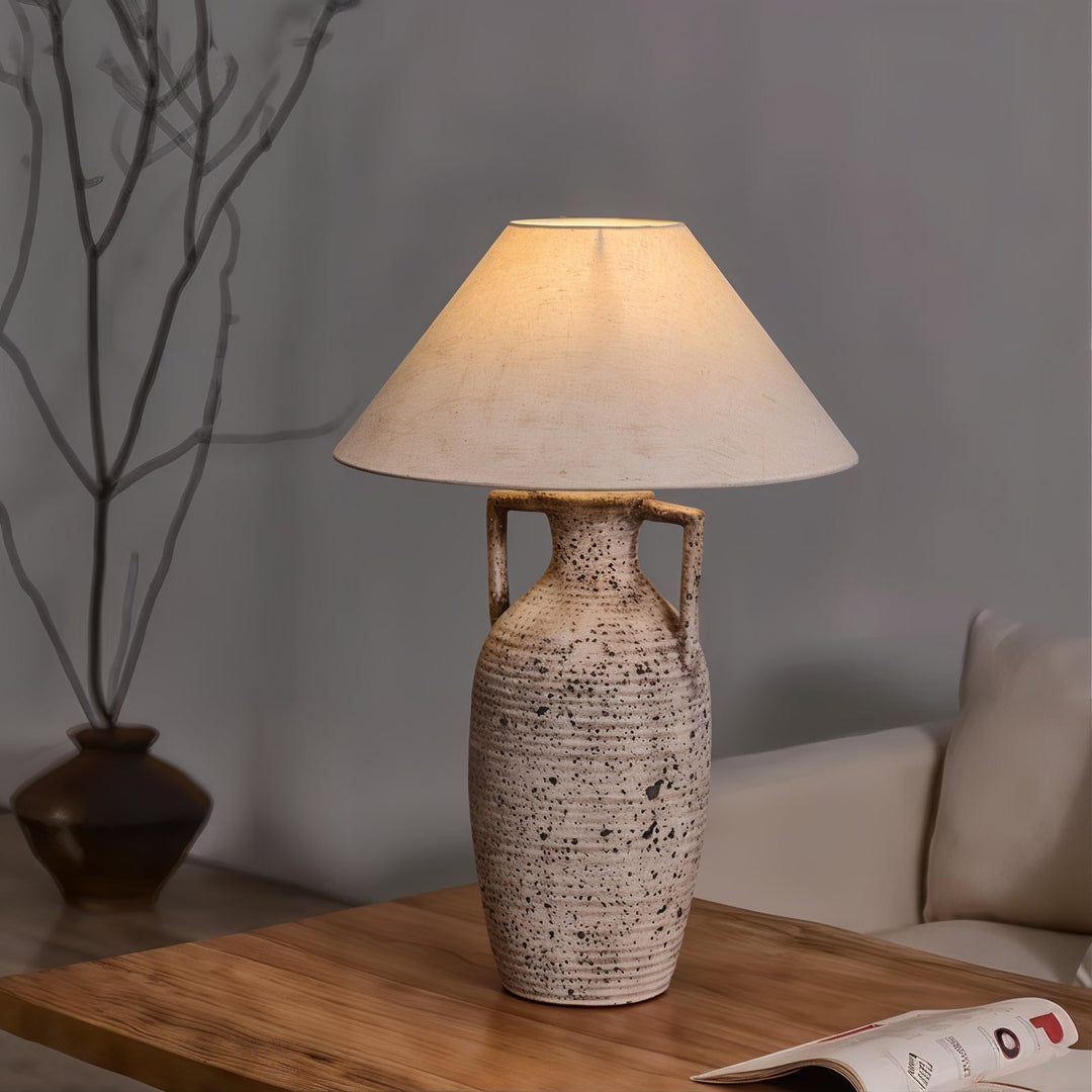 Mid Century Table Lamp - Imperfectly Perfect casting a warm glow in a serene, minimalist setting.