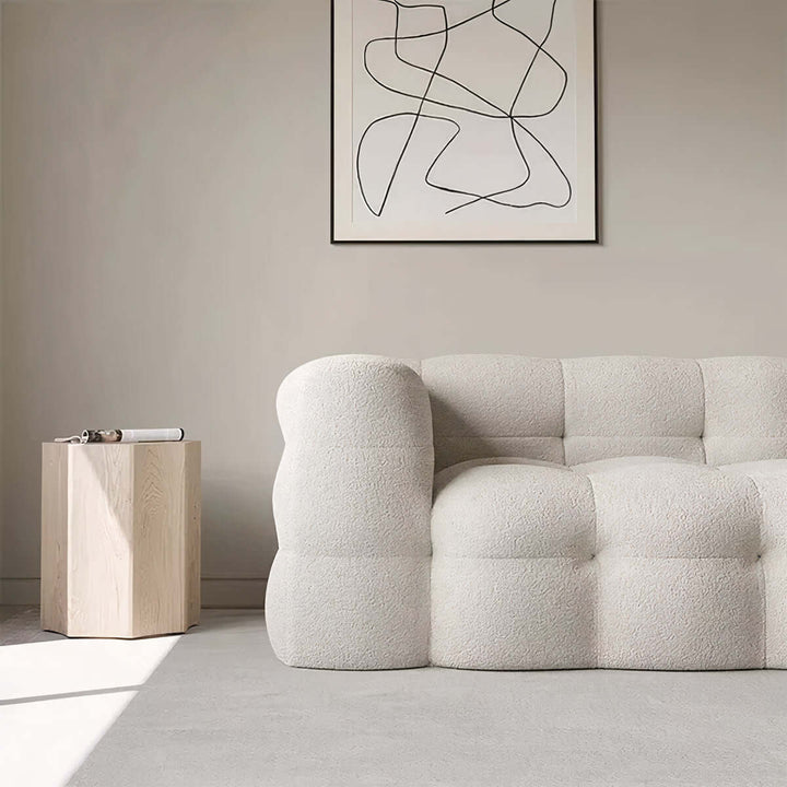Cloud Sofa - 3 Seater Sofa in a modern living room with a minimalist side table and abstract art.