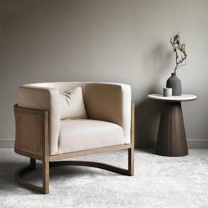 Lounge Chair - Comfortable Reading Chair in neutral linen upholstery with rattan details, perfect for cozy living rooms.