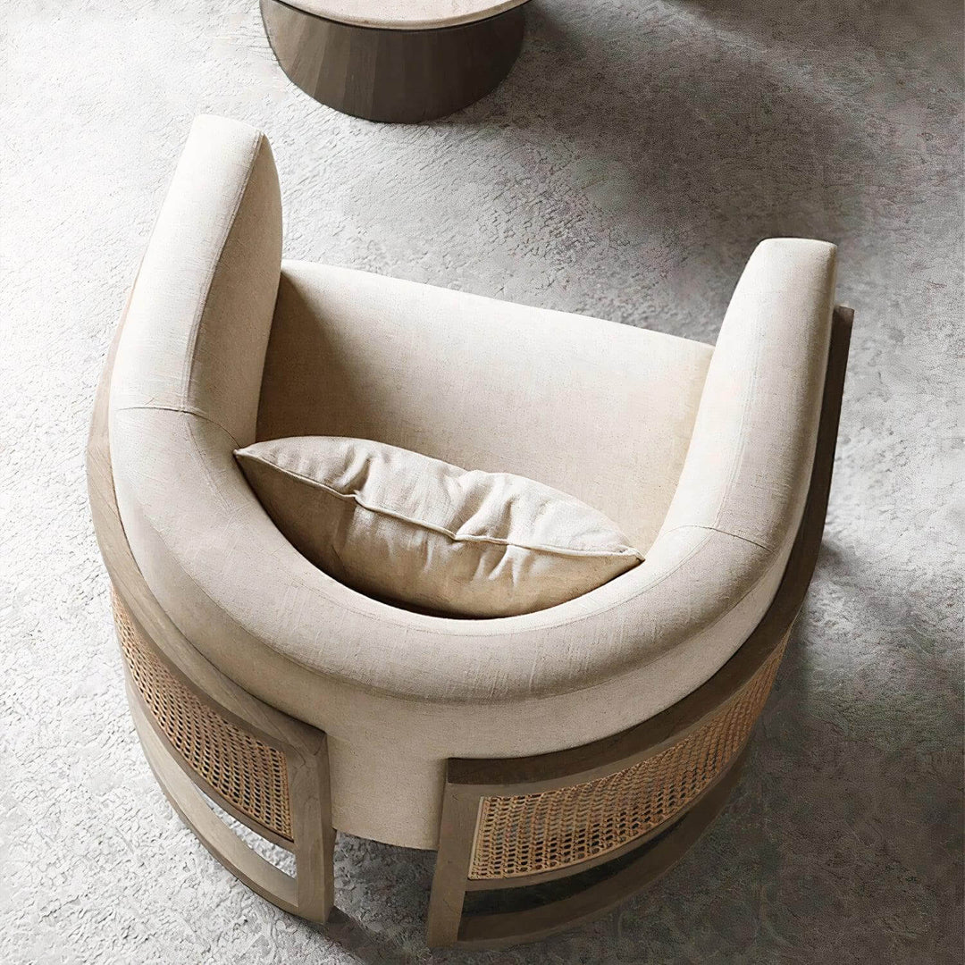 Lounge Chair - Comfortable Reading Chair featuring soft linen upholstery and rattan details, perfect for relaxing with a book.