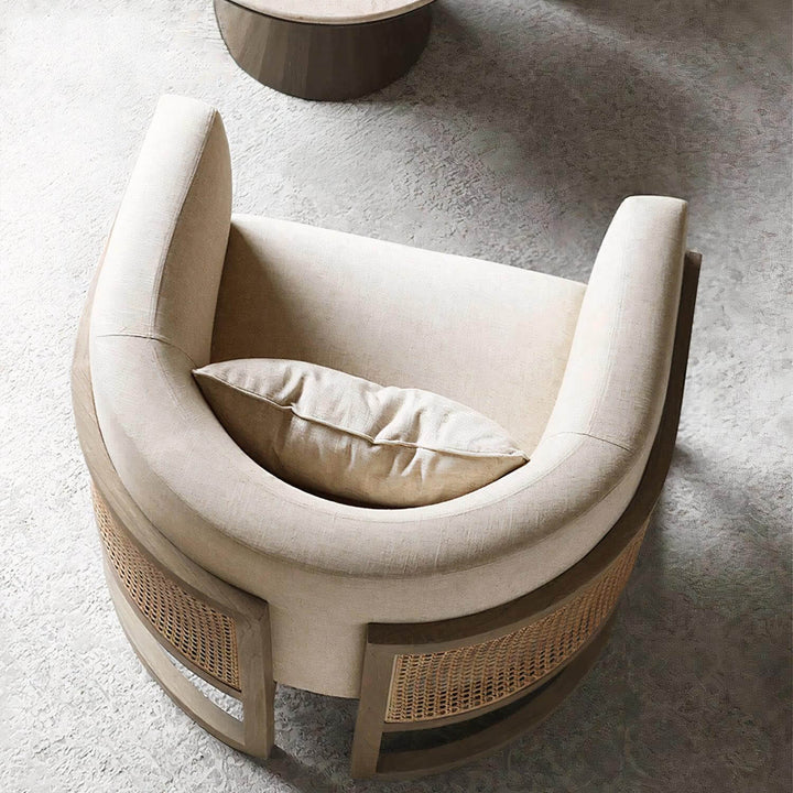Lounge Chair - Comfortable Reading Chair featuring soft linen upholstery and rattan details, perfect for relaxing with a book.