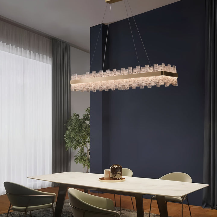 Gold Chandelier - Linear Chandelier illuminating a modern dining area with elegant glass accents.