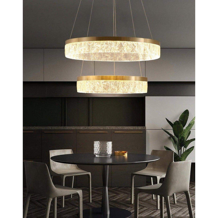 Staircase Chandelier - Foyer Chandelier illuminating a modern dining area with gold finish and LED lights.