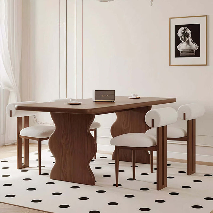 Dark Wood Dining Table - Lavish & Finesse with sculpted legs and modern chairs on a polka dot rug.