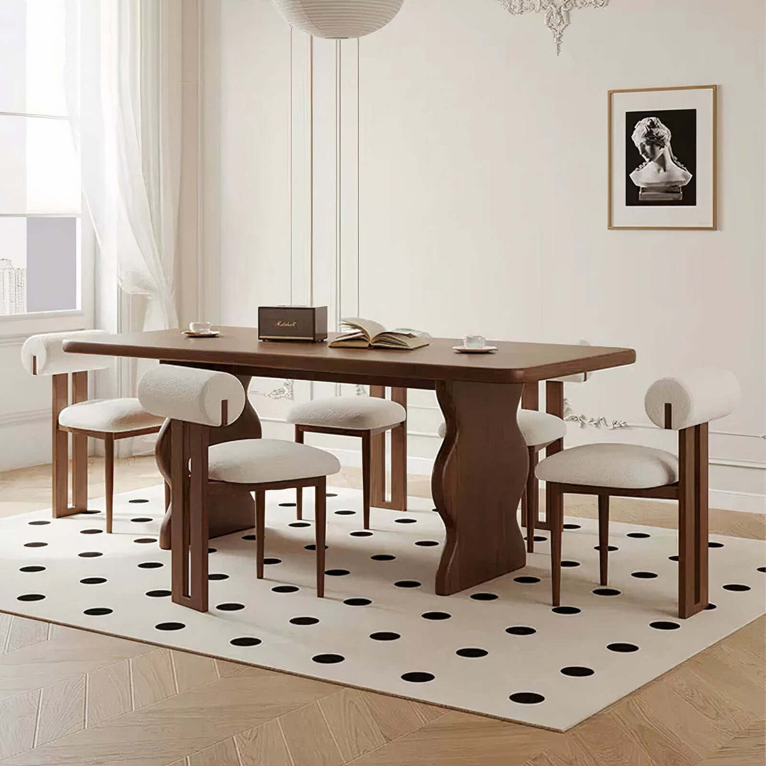 Dark Wood Dining Table - Lavish & Finesse showcasing elegant design and sculpted legs in a modern dining area.