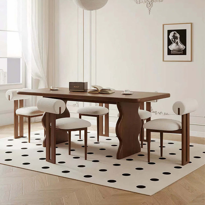 Dark Wood Dining Table - Lavish & Finesse showcasing elegant design and sculpted legs in a modern dining area.