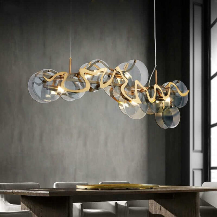 Modern gold chandelier with glass plates, offering contemporary design and warm ambiance in a stylish dining setting.