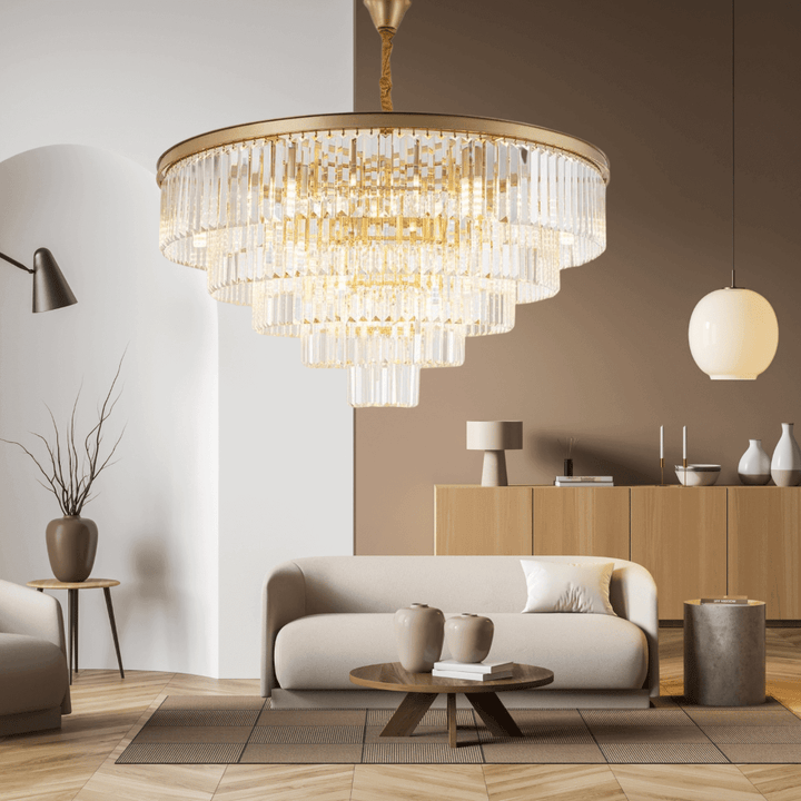 Stylish Gemima Round Golden Crystal Chandelier illuminating a modern living room with elegant decor.