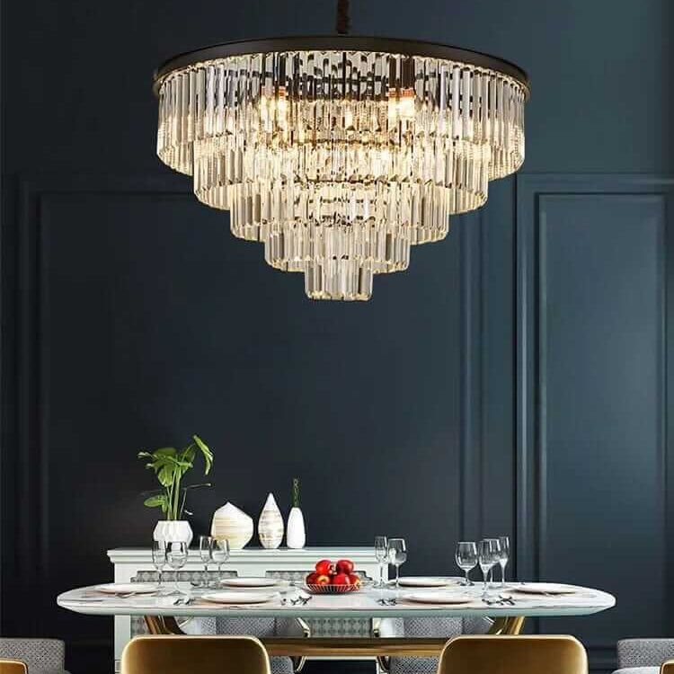 Gemima Round Golden Crystal Chandelier illuminating an elegant dining space with modern decor and stylish table setting.