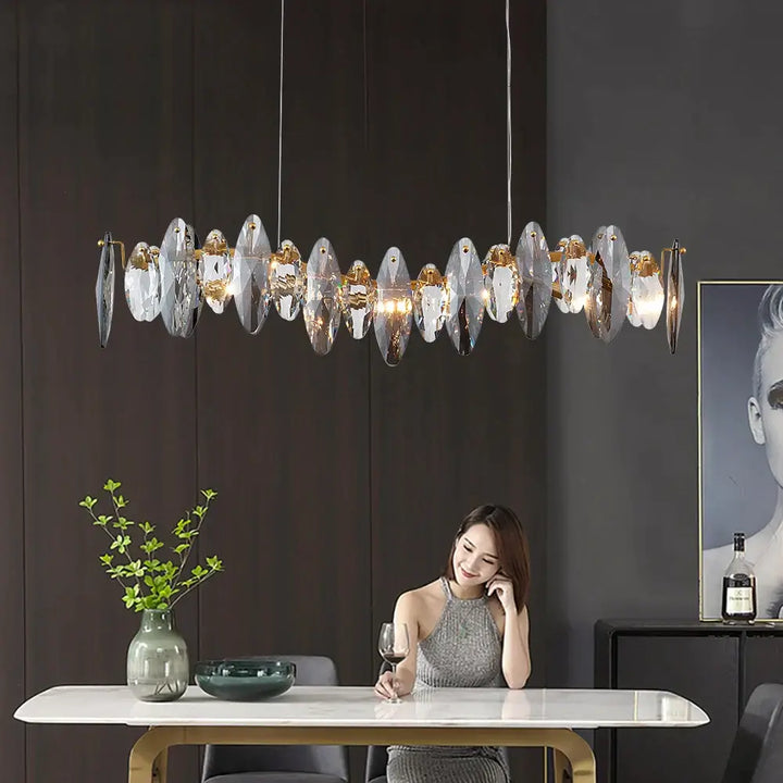 Elegant woman dining under Allora Creative Art Long Restaurant Crystal Chandelier, showcasing sophisticated illumination.