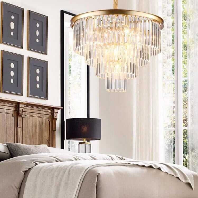 Luxurious Gemima Round Golden Crystal Chandelier illuminating a stylish bedroom with elegant decor.
