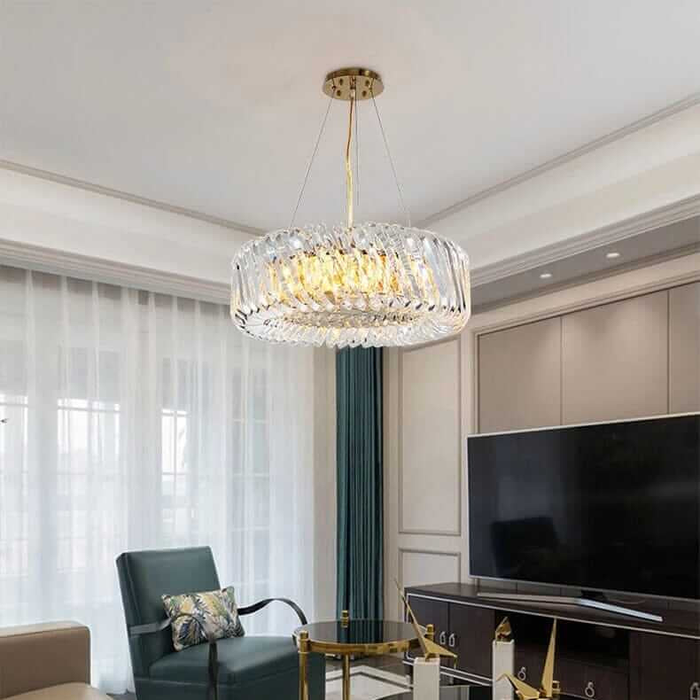 Stylish entryway chandelier with gold finish and crystal accents illuminating modern living room decor.