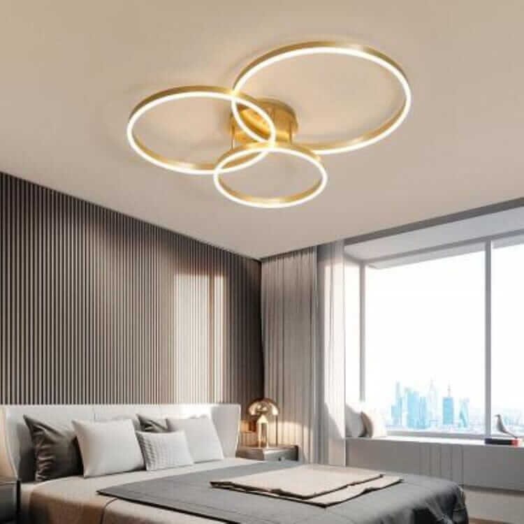 Modern LED chandelier featuring three circular rings, adding elegance to a contemporary bedroom.