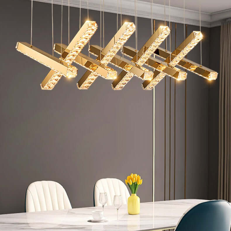 Modern gold pendant light fixture in a dining room setting.