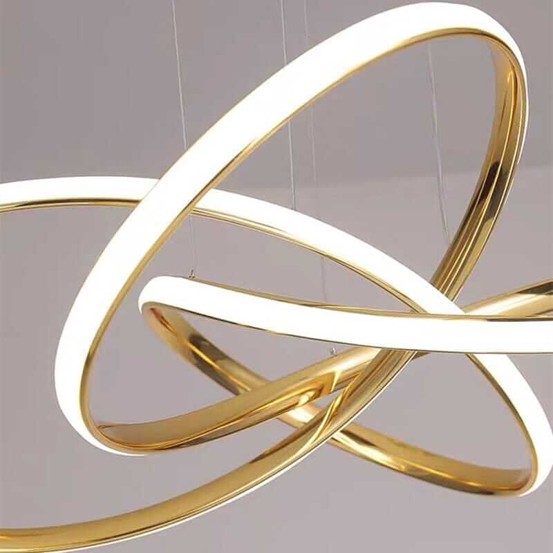 Sleek gold chandelier with interlocking rings and integrated LED lighting for contemporary elegance.